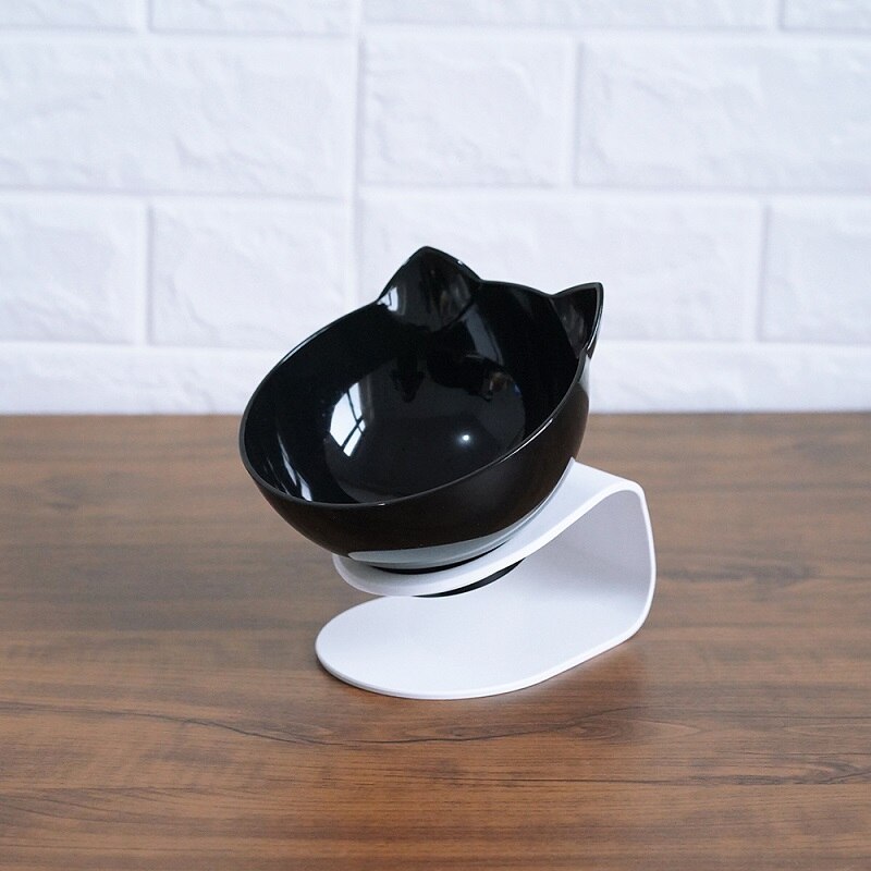 Black cat head bowl set with a stylish white stand, tilted design for pet comfort during mealtime.